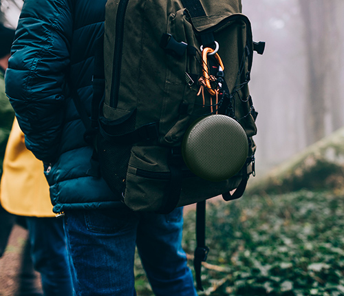BeoPlay A1 in Moss Green on backpack